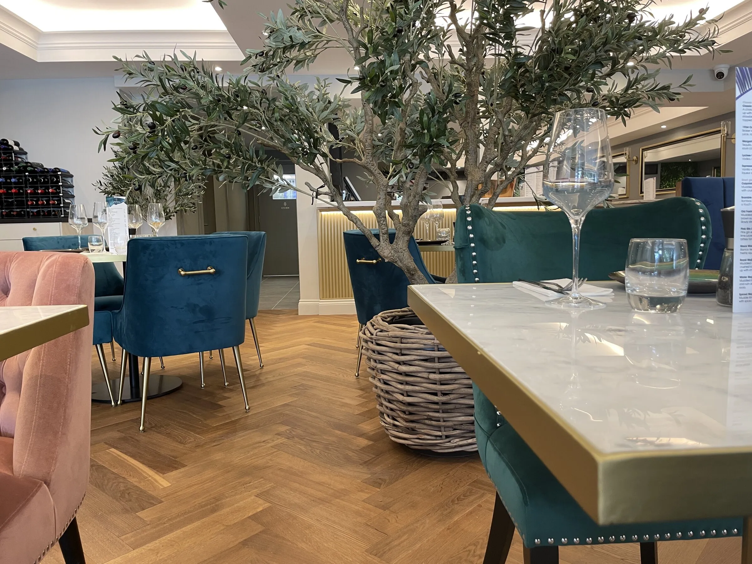 Tables set for dinner at Zeitoun Claygate, velvet chairs and marble tables