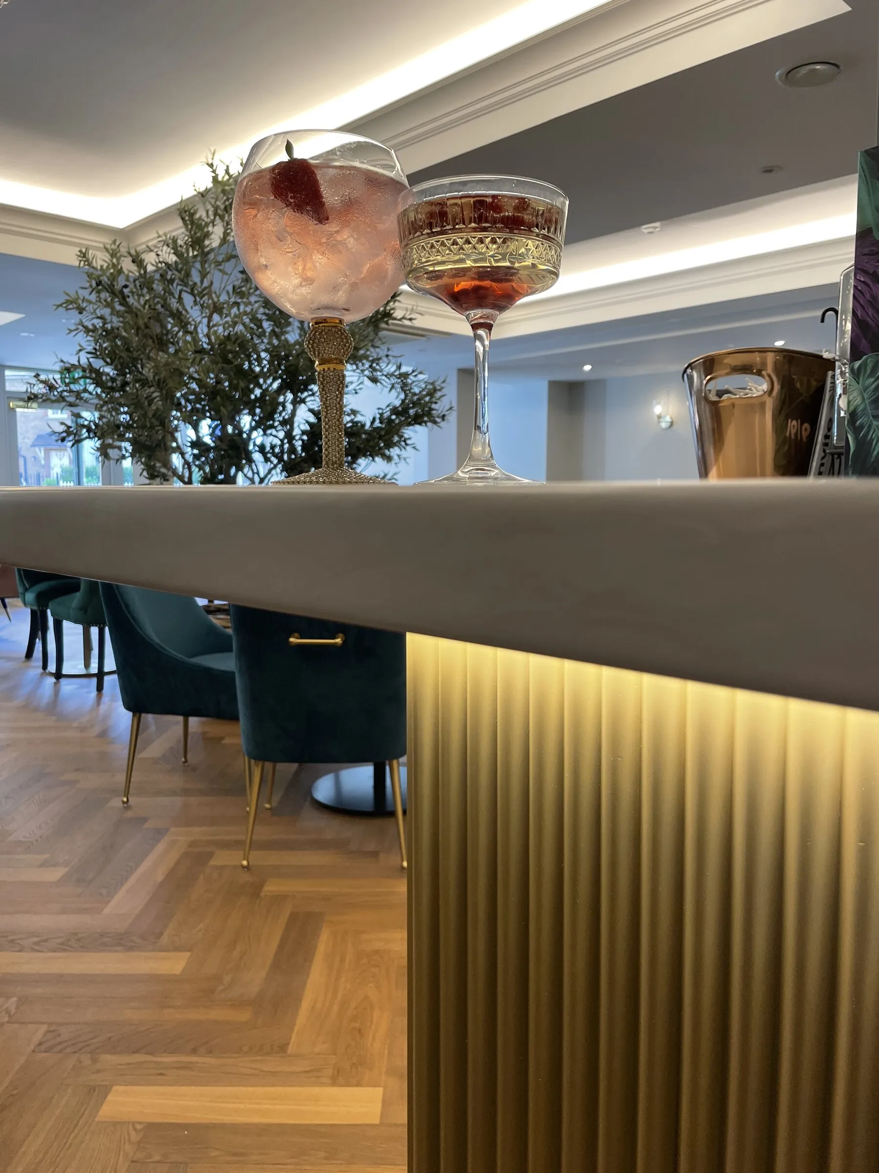The bar at Zeitoun, glassware overhead and the dining room beyond